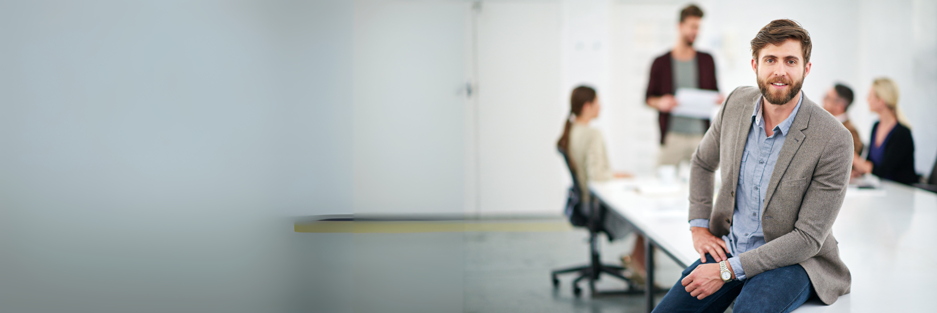 Business man sitting on a desk.