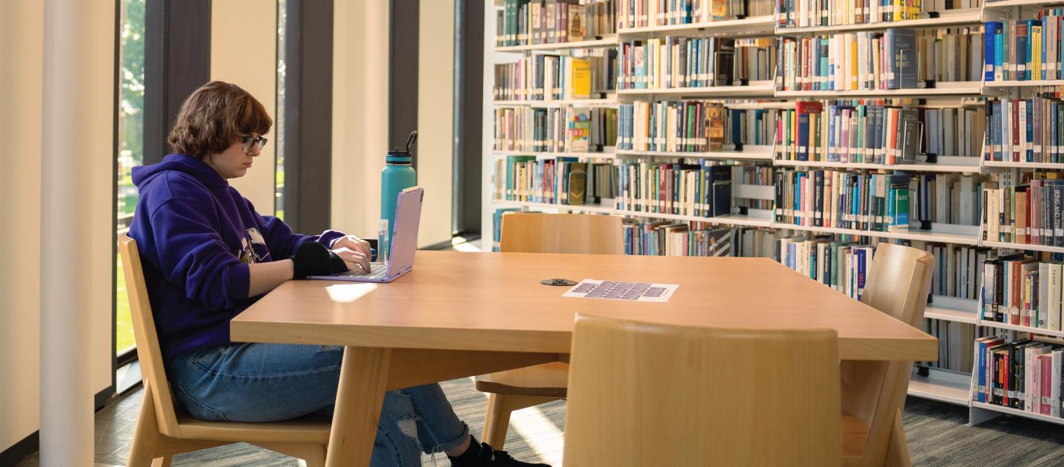 Student in library on laptop