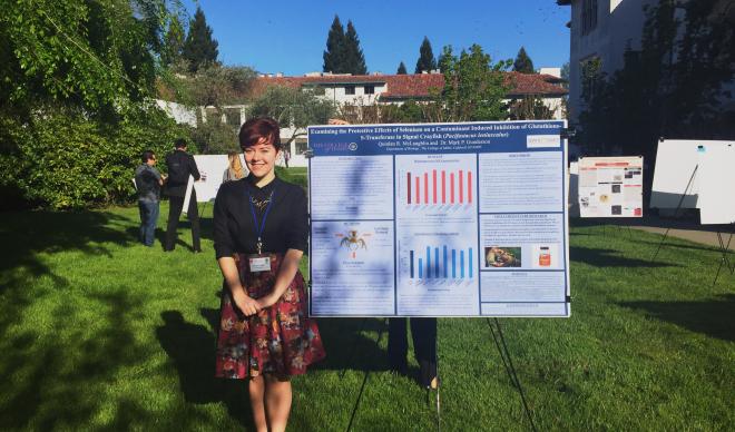 Quin McLaughlin stands with her award winning poster at the 43rd Annual West Coast Biological Sciences Undergraduate Research Conference.