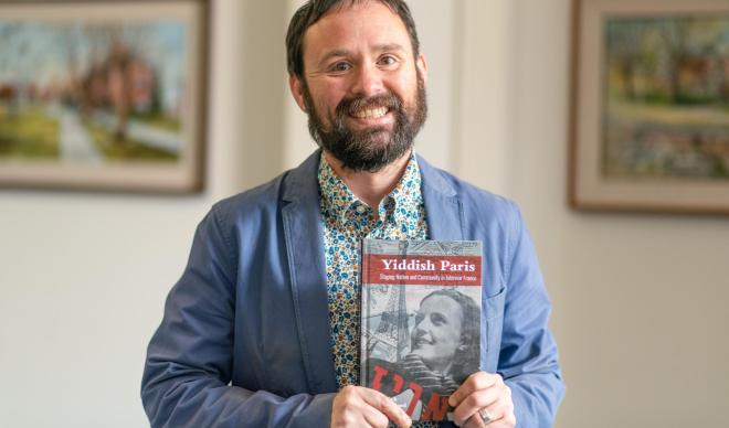 Nick underwood with his book "Yiddish Paris"