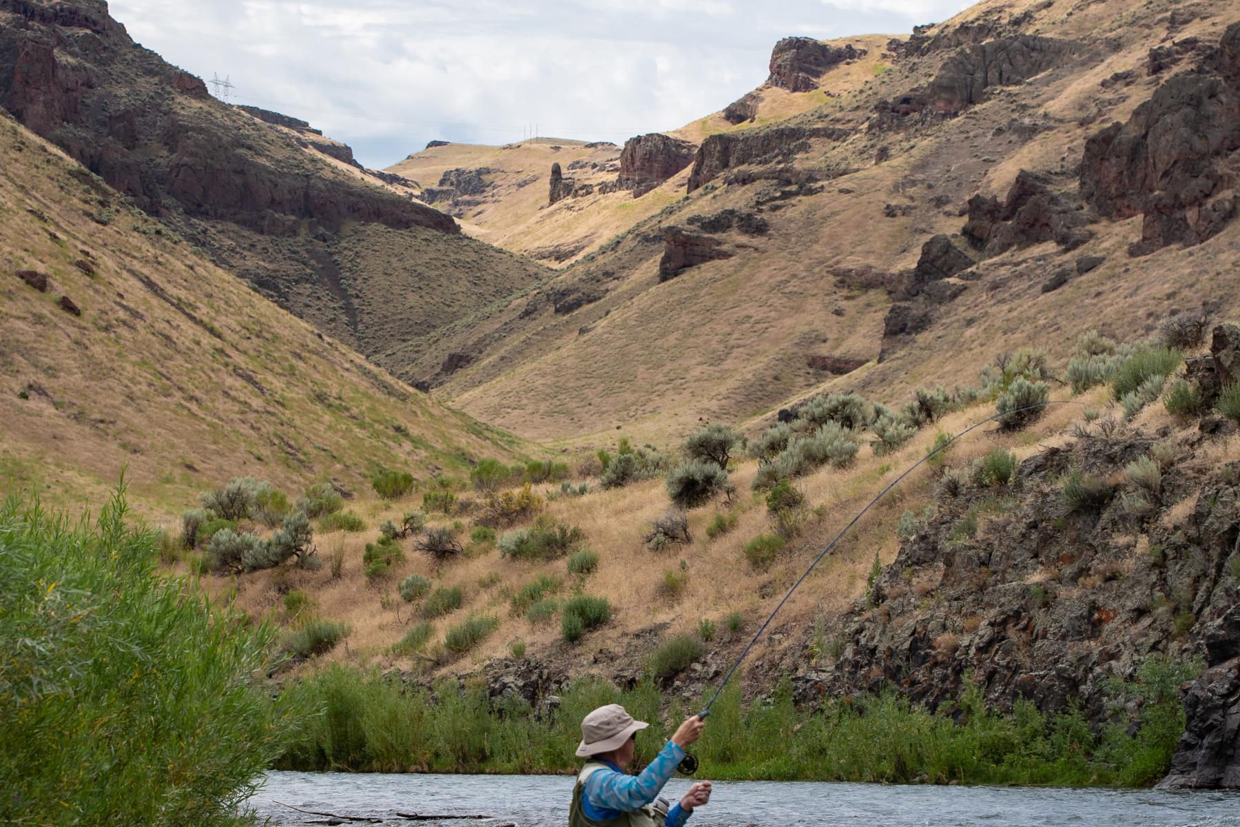 man fishing in idaho river