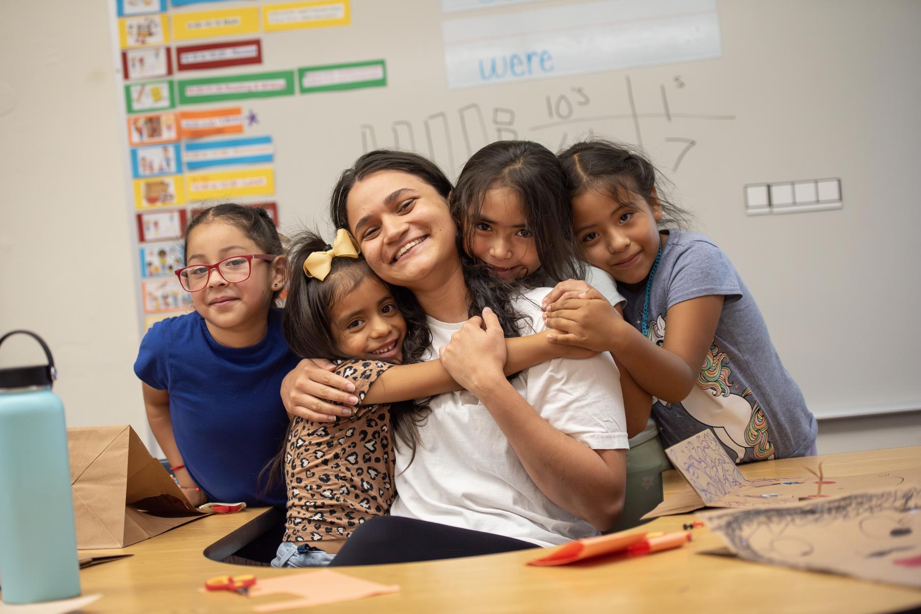 student with kids at the YMCA Summer Bridge program in Ketchum