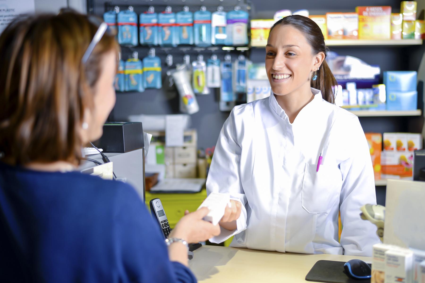 female-pharmacist-staff-counseling-customer-about