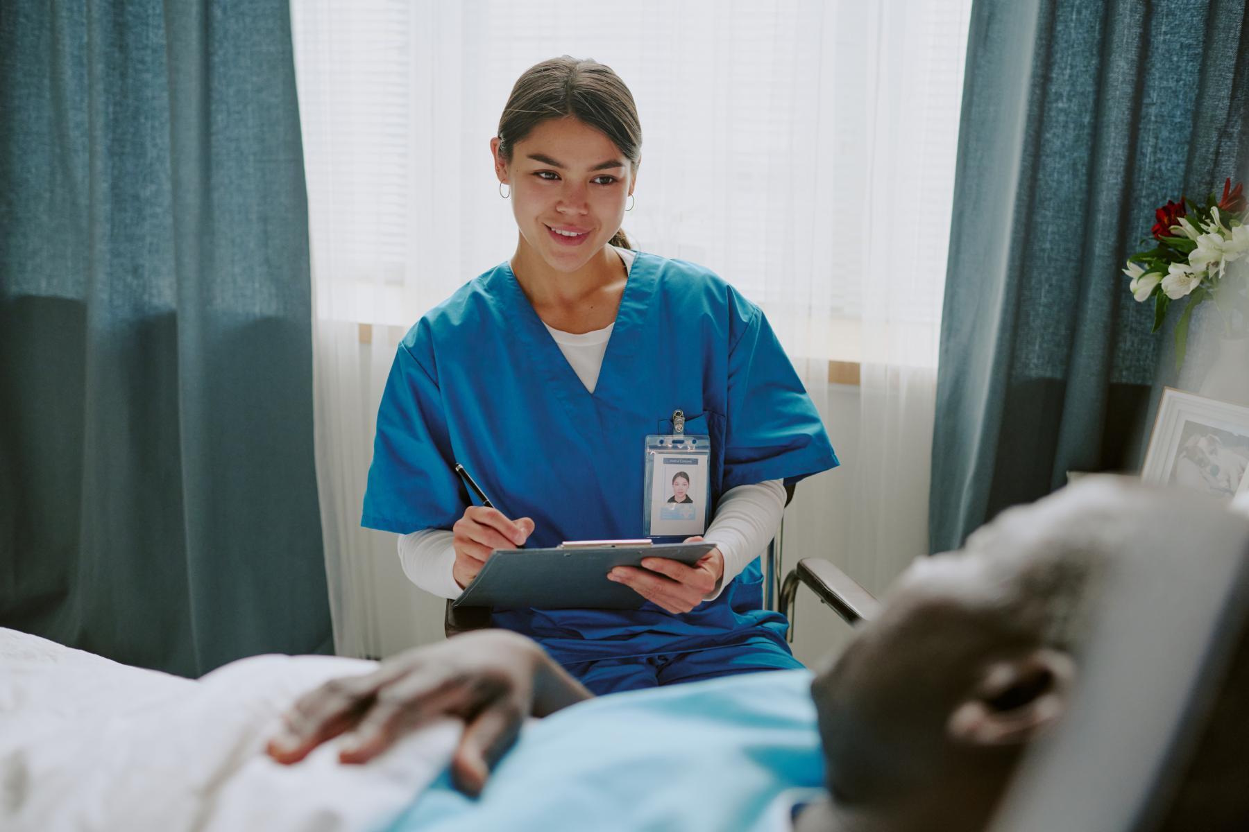 nurse-interacting-with-elderly-patient-in-hospital