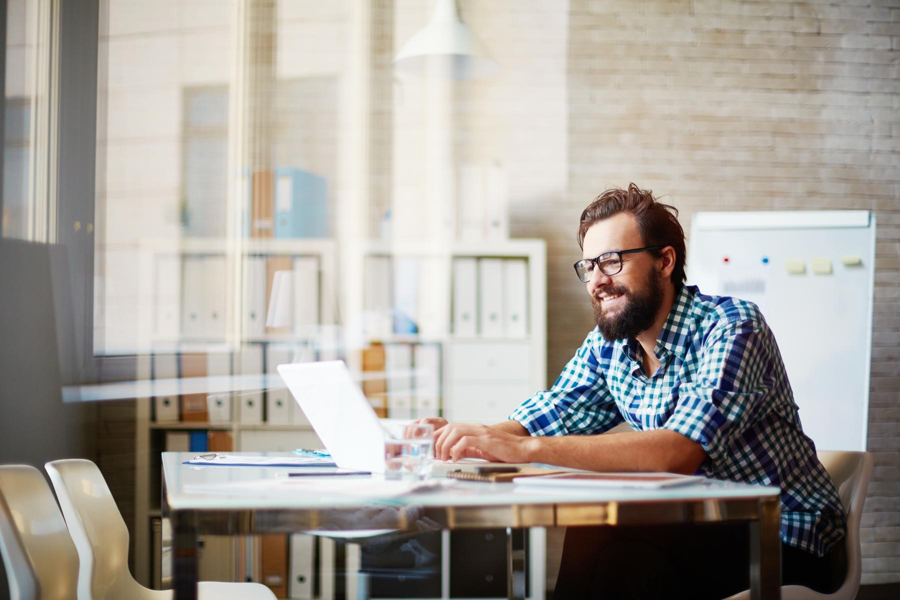 Man at desk applying for program. 